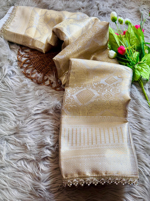 Luxurious Banarasi silk in antique zari, adorned with: