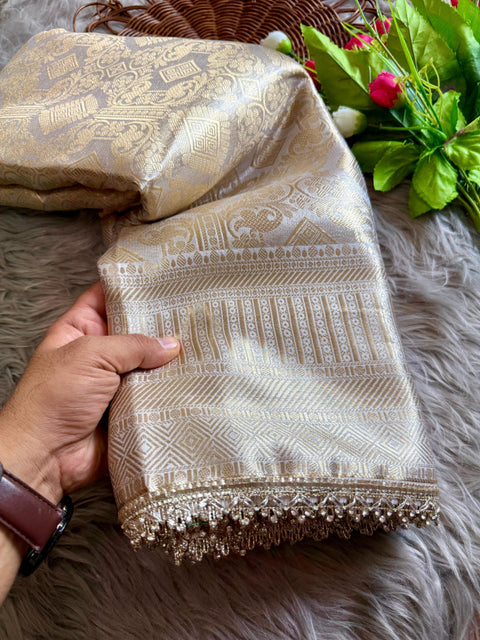 Luxurious Banarasi silk in antique zari, adorned with: