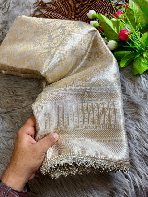 Luxurious Banarasi silk in antique zari, adorned with: