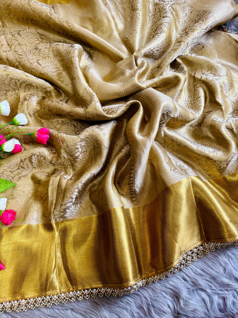 this golden tissue silk saree has beautiful ghungroo and pearl border