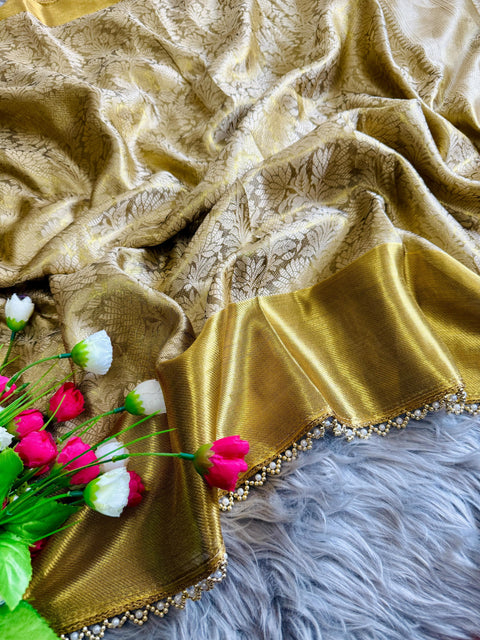 this golden tissue silk saree has beautiful ghungroo and pearl border